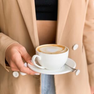 person holding white ceramic cup filled with coffee