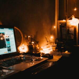 black laptop computer turned on beside black corded computer keyboard