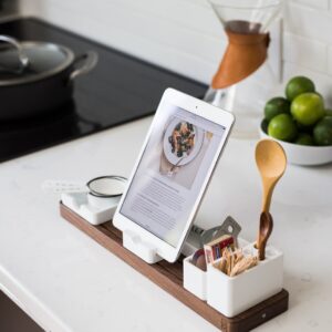 closeup photo of turned on iPad with rack on table