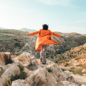 person standing on cliff during daytime