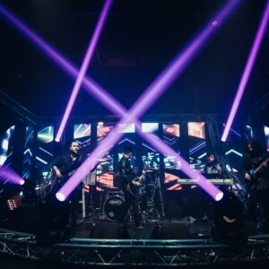 people standing on stage with blue lights