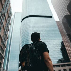 man standing near high rise buildings