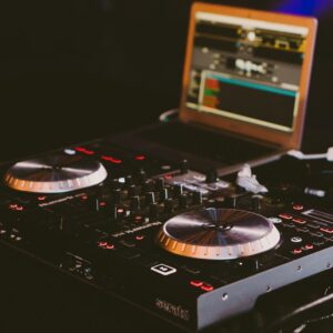 black DJ turn table next to laptop computer