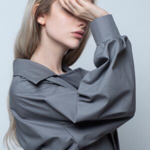 woman in black long sleeve shirt covering her face