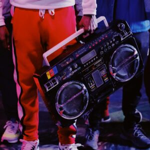 man in red jacket holding black dj controller