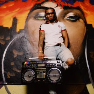 man in white t-shirt holding black camera